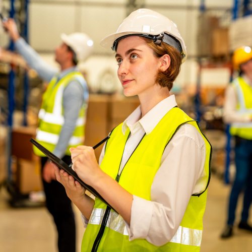 A warehouse manager taking inventory.