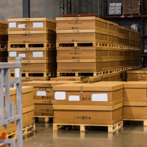 Boxes on pallets inside of a warehouse.